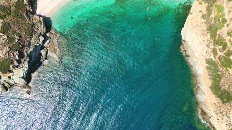 Aerial-drone-video-of-iconic-turquoise-and-sapphire-bay-and-beach-of-Andros,-Cyclades,-Greece