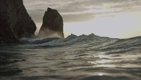 Waves-crashing-into-rocks-in-golden-hour