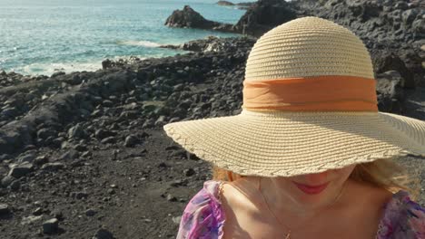 Close-up,-girl-wearing-big-summer-hat-covering-her-face,-Tenerife