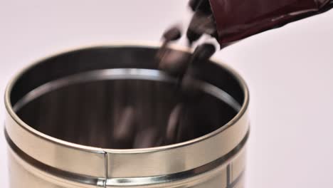 Filling-a-metal-container-with-roasted-coffee-beans