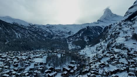 The-town-and-Ski-resort-Zermatt,-Switzerland-aerial-Drone-video-with-the-matterhorn-and-Alps-mountains-in-the-background