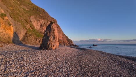 Copper-Coast-Waterford-Ireland-golden-hour-on-pebble-beach-at-full-tide-on-a-perfect-day-natures-finest