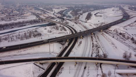 Revealing-Aerial-Shot-of-a-Winter-Highway-and-Railroad-in-Canada