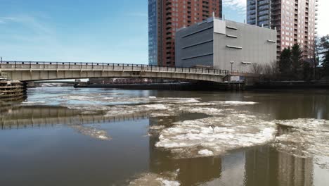 ice-drifiting-down-river-Wilmington-Delaware-winter-drone-slow-left-to-right-shot