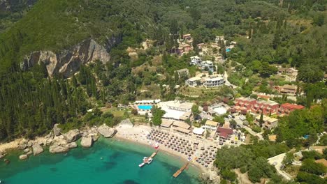 Paleokastritsa-holiday-resort-to-Corfu-scenic-mountain-terrain-AERIAL-FLYOVER