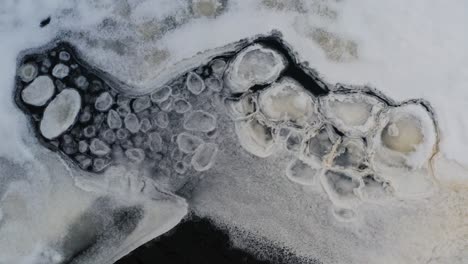 Aerial-view-of-ice-shape-formations-float-near-frozen-lake-ice-sheet
