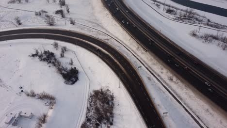 Aerial-View-of-a-Car-Taking-an-Exit-from-a-Busy-Winter-Highway