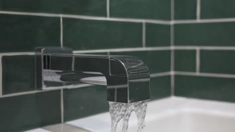 Slow-motion-clip-of-a-faucet-in-a-newly-redesigned-bathroom