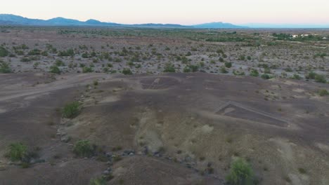 Approaching-Blythe-Intaglio-Geoglyphs-over-Sonoran-Desert,-Terrain-Below-and-Skies-Above-Mountain-Range