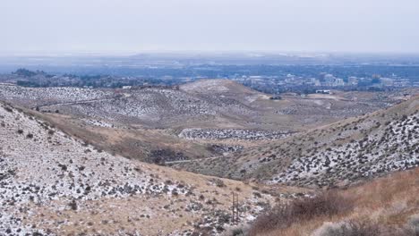 Panoramic-view-of-Boise-city-from-snow-covered-mountains-during-crisp,-cold-wintery-fall-season-day-in-Boise,-Idaho,-USA
