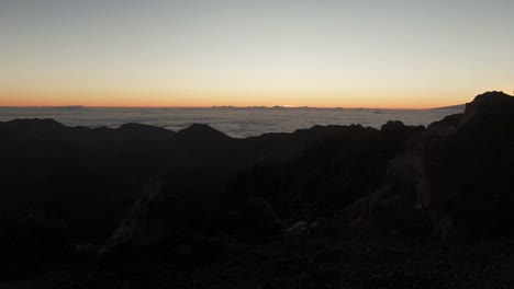 View-over-clouds-from-Haleakala-volcano-at-sunset-on-Maui,-Hawaii