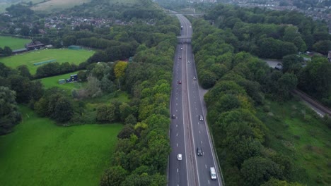 Titling-Drone-Shot-of-Cars-Passing-on-Motorway