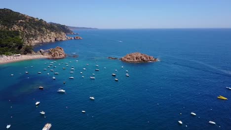 Flying-above-a-port-of-yachts-and-boats,-next-to-the-coast-of-the-Mediterranean-Sea