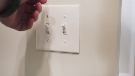 Turning-on-a-lightswitch-in-a-newly-built-bathroom
