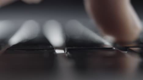 Extreme-Close-up-of-Finger-Pressing-Keys-on-Laptop-Keyboard