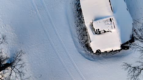 aerial-looking-down-on-roof-of-snow-covered-home-in-appalachia