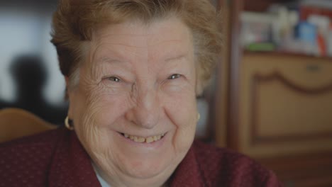 Elderly-woman's-joyful-expression-looks-into-the-camera,-Close-up