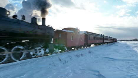 Establishing-shot-of-a-passenger-train-on-a-snowy-day