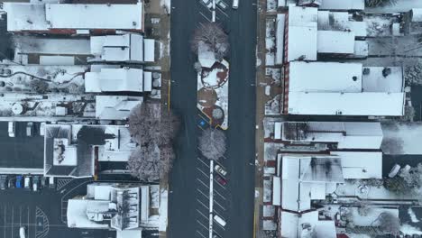 Top-down-aerial-above-snow-covered-town-square-in-USA