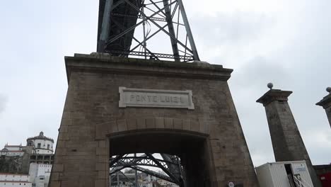 Dom-Luis-I-Bridge-or-Ponte-Luiz-I-sign-against-grey-sky,-Porto