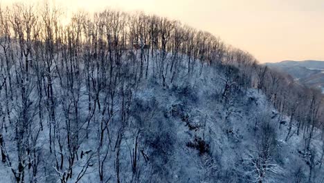 aerial-push-into-the-sunset-in-winter-near-boone-nc,-north-carollina