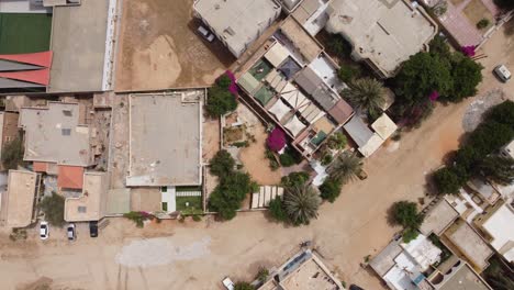 Bird's-Eye-View-Drone-Shot-of-Hotel-in-Nouakchott,-Mauritania,-with-Tents-on-Roof
