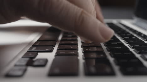 Low-angle-Close-up-of-Caucasian-Fingers-Typing-on-Laptop-Keyboard
