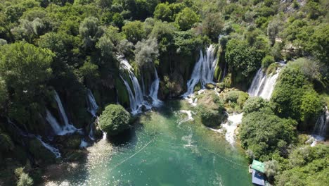 Aerial-orbit-Kravica-Waterfall-in-Bosnia-and-Herzegovina,-sunny-summer-day