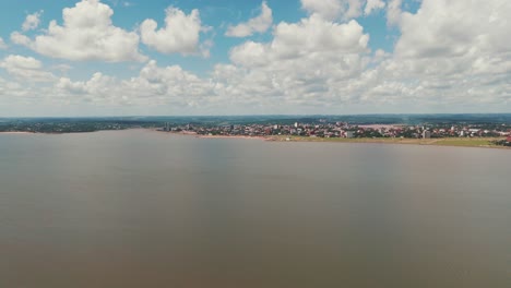 Long-shot-image-of-the-coastal-city-Encarnación-in-Itapúa,-Paraguay,-highlighting-the-cityscape-and-its-picturesque-waterfront