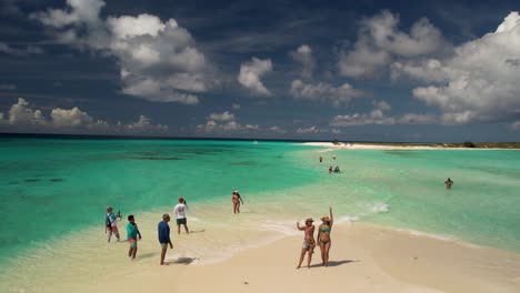 people-enjoy-pristine-beach-bliss,-caribbean-luxury-destination,-aerial-view-Cayo-de-agua