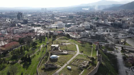 Drone-view-castle-in-the-center-of-Skopje-is-among-the-buildings,-stone-castle-in-the-city-center