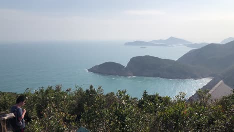 Tourists-enjoy-the-view-at-a-viewing-point-on-the-Sai-Kung-East-Country-Park,-Hong-Kong