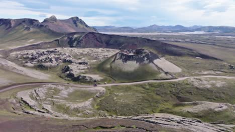 Aerial-drone-view-with-an-orbiting-left-movement,-focusing-on-Stutur-Crater-with-the-Norðurnámshraun-lava-field-on-the-left,-in-Landmannalaugar