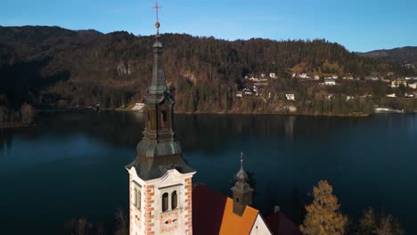 Aerial-Pullback-Reveals-Famous-Church-on-Bled-Island-at-Lake-Bled,-Slovenia