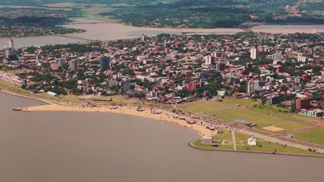 Aerial-view-of-Encarnación,-Paraguay,-featuring-its-beautiful-beach-and-restaurants