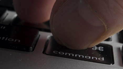 Close-up-of-Finger-Pressing-"Command-Z"-Key-Combination-on-Laptop-Keyboard