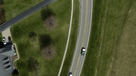 Pickup-truck-driving-down-scenic-suburban-road