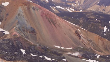 Fixed-global-view-of-the-multicolored-Brennisteinsalda-mountain,-featuring-solfataras,-sulfur-fumaroles,-and-smoke-at-the-bottom