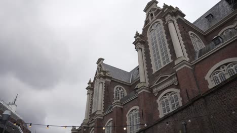 Dutch-architectural-building-exterior-view-in-Amsterdam-city-center-during-cloudy-winter-day
