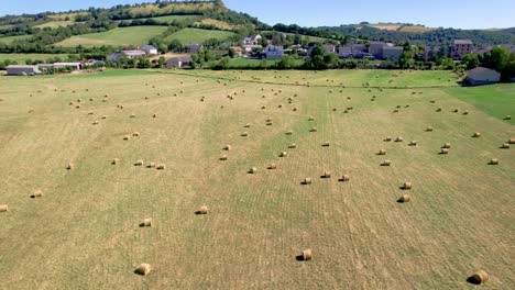 Hay-bales-on-field-in-French-countryside,-Aveyron-in-Occitania,-Southern-France