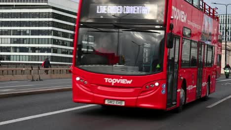 London-Buses-driving-past,-London-Bridge,-United-Kingdom