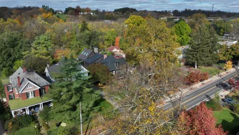 Aerial-view-of-a-suburban-street-with-traditional-houses-amidst-colorful-autumn-foliage