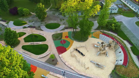 Aerial-establishing-overview-of-modern-childrens-play-park-area-with-innovative-wooden-jungle-gym