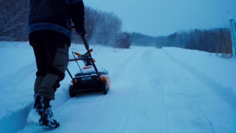 A-Man-is-Using-a-Snow-Blower-to-Clear-the-Road---Static-Shot
