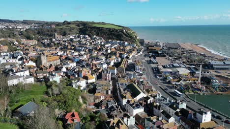 Aerial-drone-shot-of-Hastings-UK,-flying-over-town,-amusement-park-and-Land-Based-Fishing-Fleet