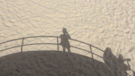 Shadow-Of-People-On-Sand-On-A-Sunny-Day-In-Bondi-Beach,-Australia