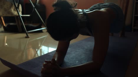 Beautiful-south-Asian-woman-doing-plank-exercises-in-the-living-room-of-her-home