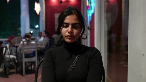 Sexy-South-Asian-Woman-in-contemplation-at-a-café,-evening