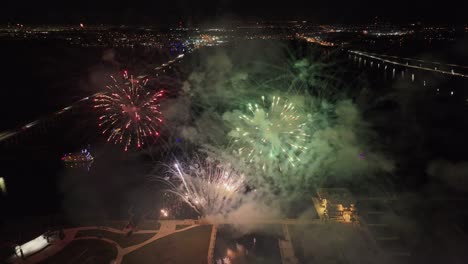 Large-colorful-firework-with-skyline-of-Fort-Myers,-Florida,-aerial-view