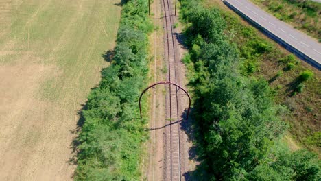Railway-leading-through-countryside-of-France,-aerial-drone-view